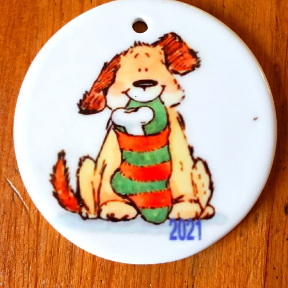 Dog with stocking, 3 inch white ceramic ornament